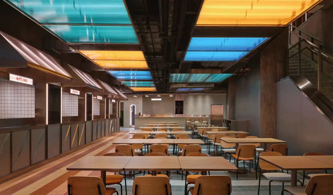 Linehouse's Kam Pek Market Macau revitalized art deco building facade with curved teal green tile entrance and neon lights on San Ma Lo street.