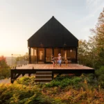 Cantilevered modern house Le Noroît by Guillaume Pelletier Architecte suspended over Laurentian forest escarpment in Wentworth-Nord, Quebec.