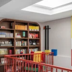 Mondrian-inspired living room with red spiral staircase and built-in library | Beijing home design by Xia Fu, Shangceng Design