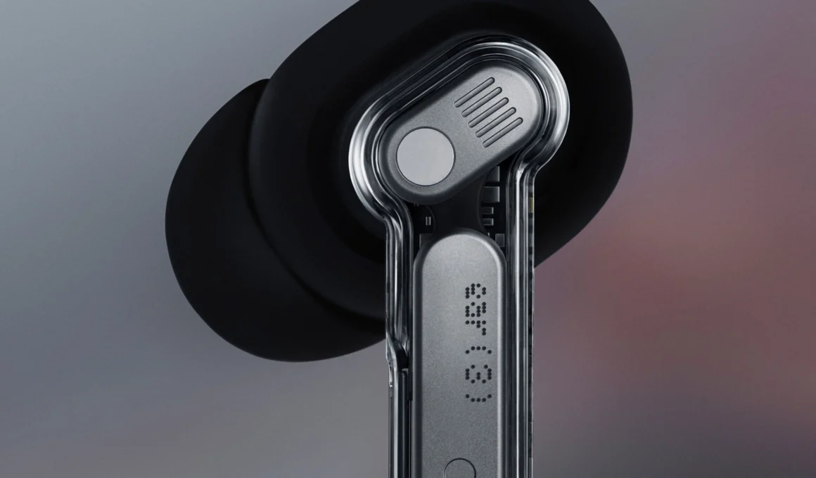 Nothing Ear (3) black and white earbuds in a transparent charging case with metal accents, showcasing the signature transparent design.