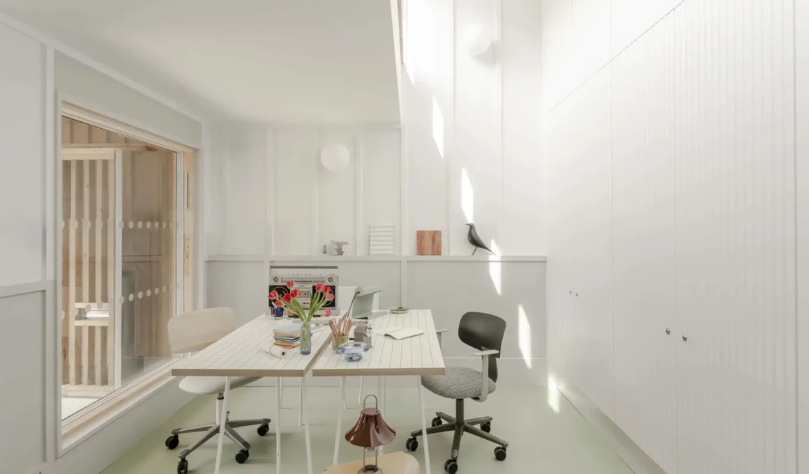 Owain Williams' Housing Centre in Haringey with warm Scots Larch cladding and rhythmic batten design.