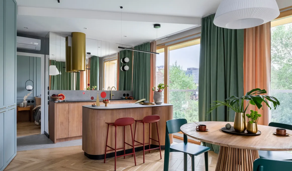 Renter-friendly living room with a modern grey armchair, lush indoor plants in design pots, and removable decor on a neutral wall.
