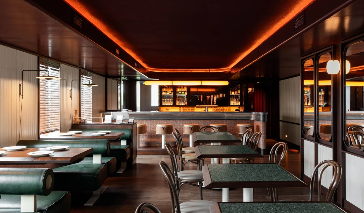 Low Rise Bar interior by MRDK in North of Brooklyn Toronto, showing marble bar, zinc countertop, and dining banquettes.