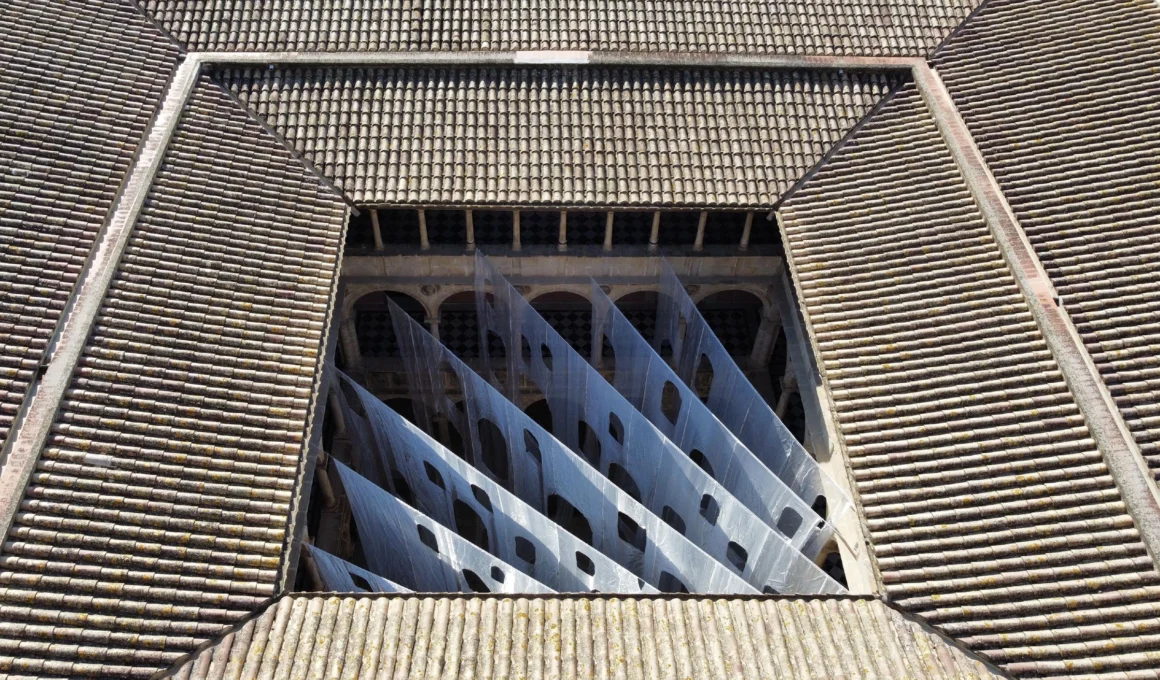 Else Umbrales de Ensueño installation in Tortosa, Spain: Translucent organza curtains blurring Renaissance courtyard arches.