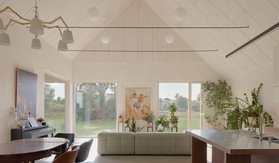 GAISS Architects House Comet living area showing exposed CLT timber structure and concrete floor in Riga