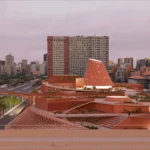 Biblioteca dos Saberes view from Sambódromo showing Kéré Architecture's perforated facade public library in Rio de Janeiro