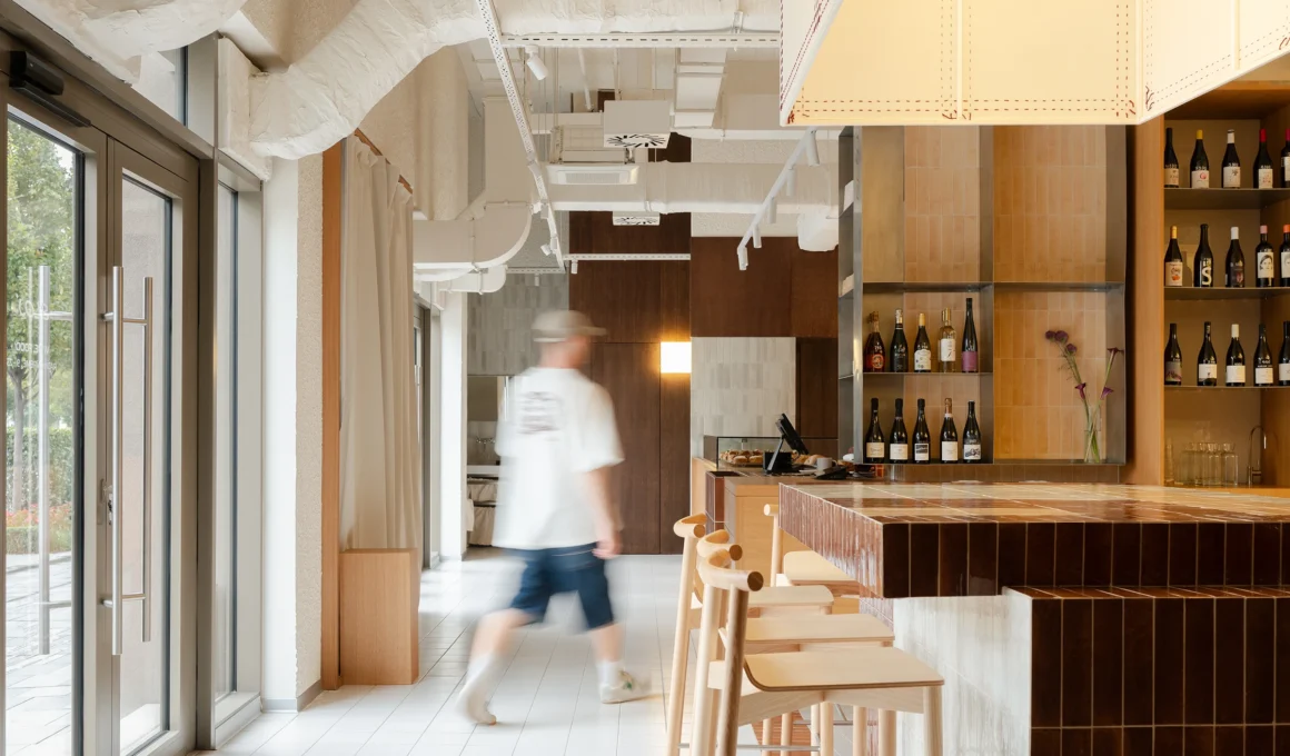 SLOJ Bakery and Bistro Belgrade interior designed by KIDZ Studio, showcasing Serbian craftsmanship and layered natural materials.