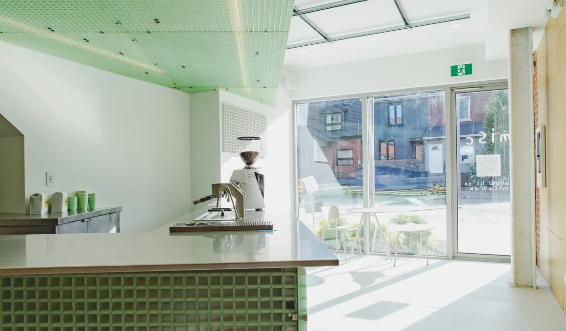 Translucent green FRP panels defining the interior of Misc Coffee Toronto, designed by StudioAC with industrial materials.