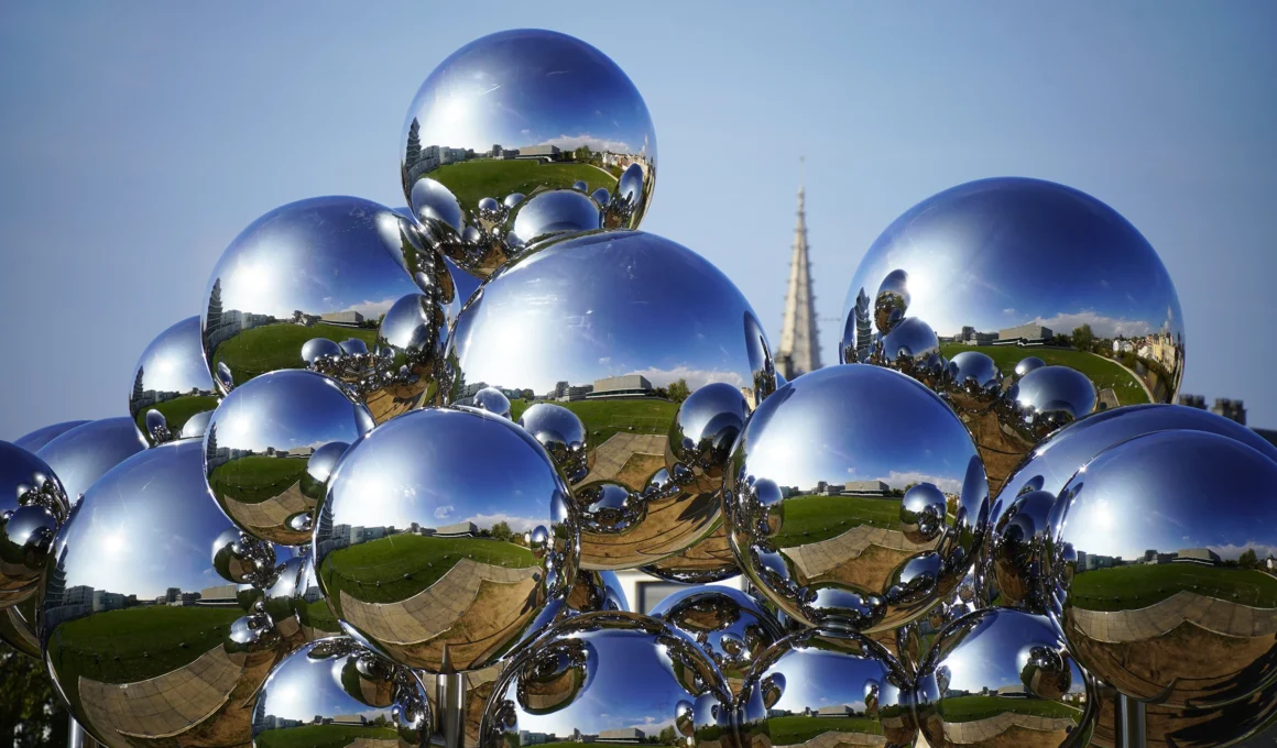 Vincent Leroy's Molecular Cloud, a large suspended kinetic sculpture of mirrored stainless-steel spheres over Caen, Normandy.