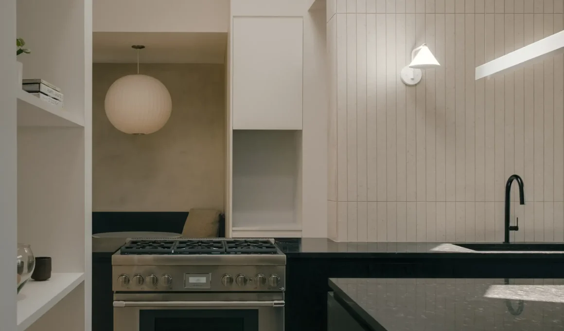 Appareil Architecture's luminous modern glazed kitchen extension in La Verrière residence, Longueuil, featuring structural columns and white oak cabinets.