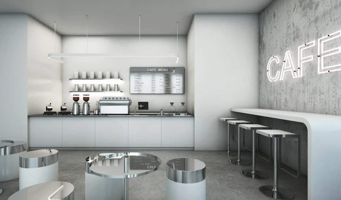 Modern loft-style café interior featuring a white gloss service counter, concrete walls with neon signage, and minimalist waiting seats on a polished concrete floor.