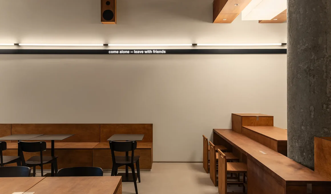 Daikan Ramen Dubai interior by KIDZ Studio featuring large-scale Japanese joinery using plywood and stainless steel.