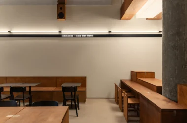 Daikan Ramen Dubai interior by KIDZ Studio featuring large-scale Japanese joinery using plywood and stainless steel.