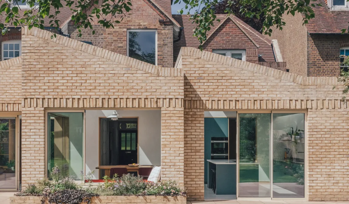 RIBA-winning Harpenden House rear extension by Emil Eve Architects featuring staggered volumes, sawtooth roof, and IDSystems ultra-slim sliding doors.
