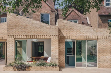 RIBA-winning Harpenden House rear extension by Emil Eve Architects featuring staggered volumes, sawtooth roof, and IDSystems ultra-slim sliding doors.