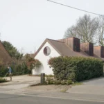 Curb view of the Home for Life in Ghent by FELT architecture & design, featuring single-storey accessible design and sculptural roof volumes.