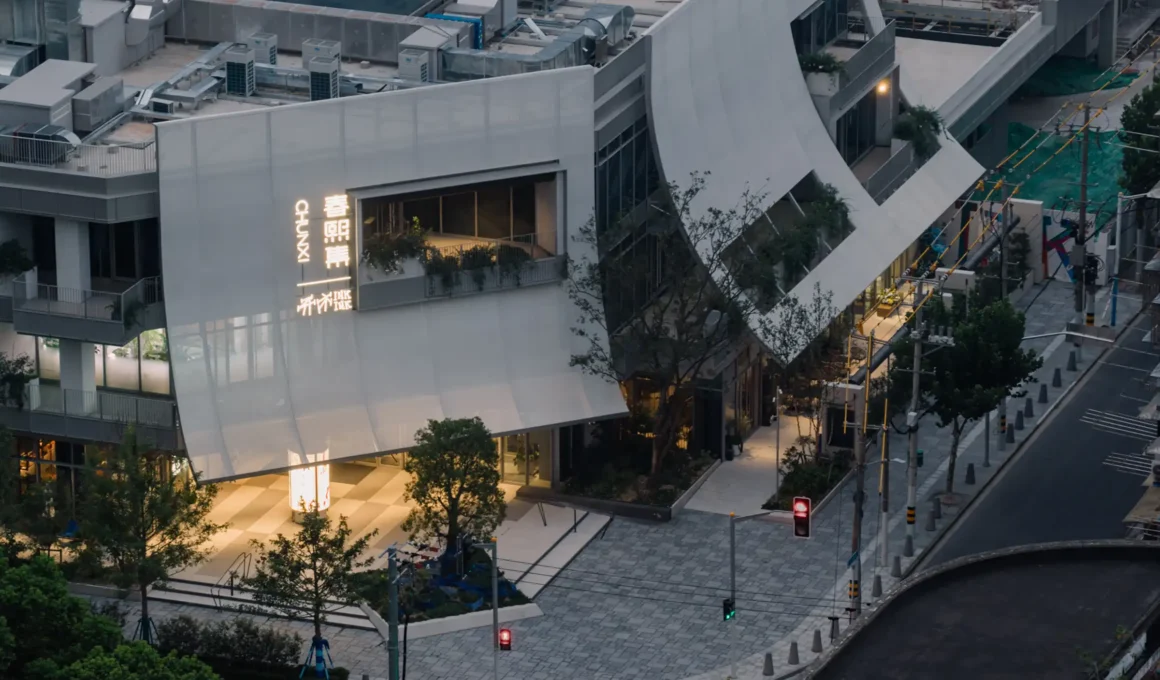 Linehouse Ink Ink Market Shanghai architecture at dusk; translucent PTFE facade, glowing entrance, and street view.