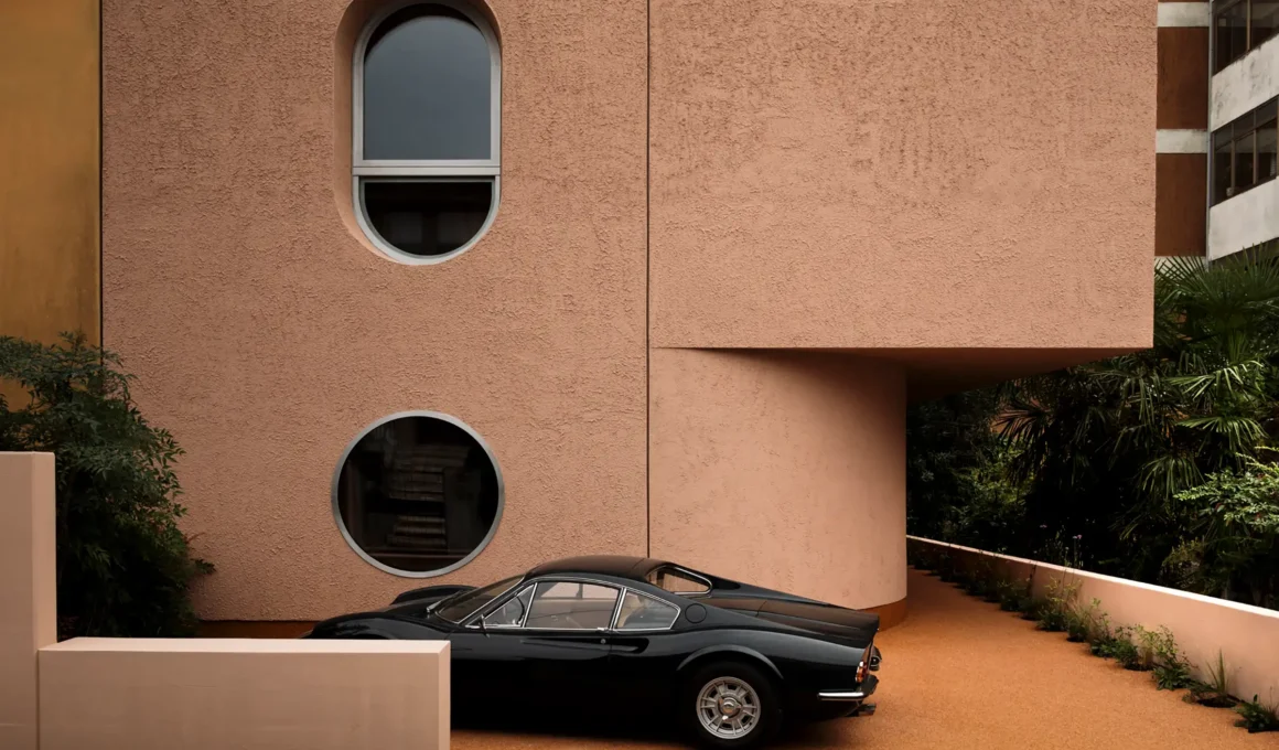 Locus Hobby House Pordenone facade: Curb view of cantilevered porch defining civic threshold architecture.