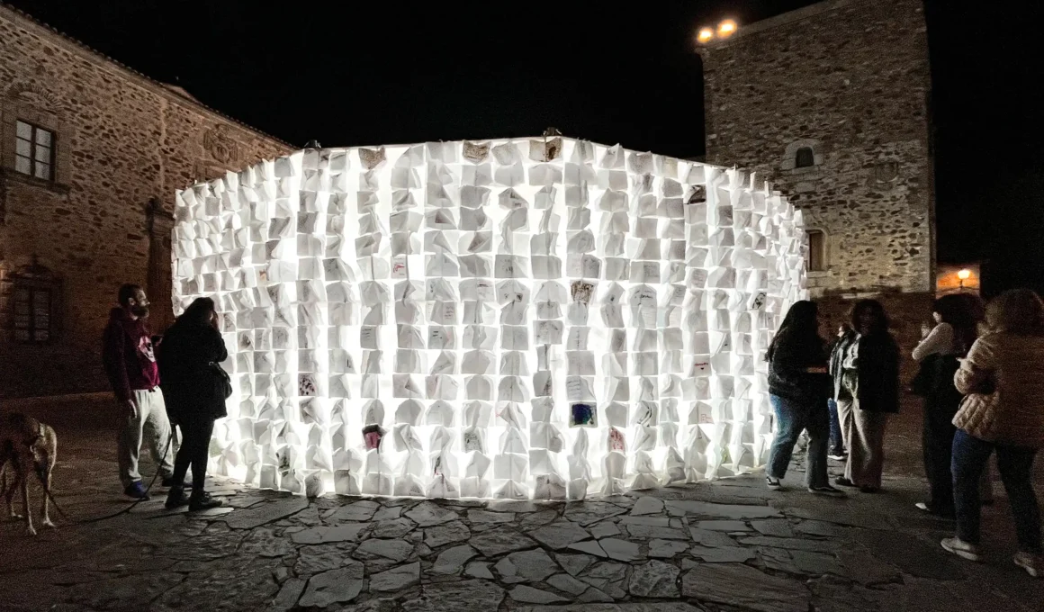Luzinterruptus Art Collective's 'On Blank Pages' glowing circular notebook wall in Cáceres, Spain, launching the European Capital of Culture 2031 bid.
