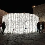 Luzinterruptus Art Collective's 'On Blank Pages' glowing circular notebook wall in Cáceres, Spain, launching the European Capital of Culture 2031 bid.