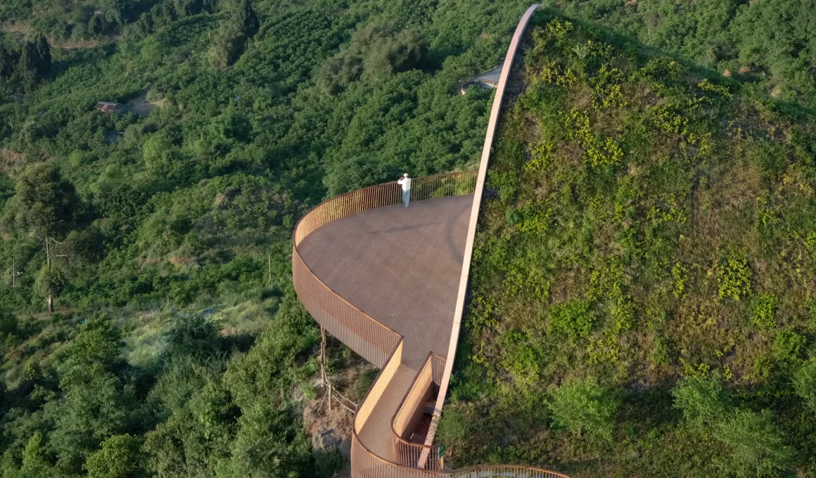 MVRDV Pujiang Platform timber pavilion with green earth-covered roof blending into scenic Chengdu hillside architecture.
