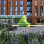 NEON’s asymmetric sculptural water fountain in green HI-MACS at Brent Cross Town, London