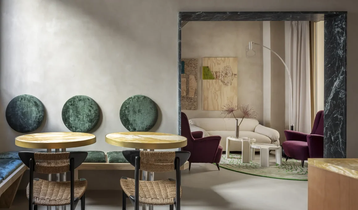 Luxury boutique hotel lobby at The Wheels Florence in Florence, showing the 14th-century coffered ceiling, eclectic design, and furnishings by Giacomo Totti.