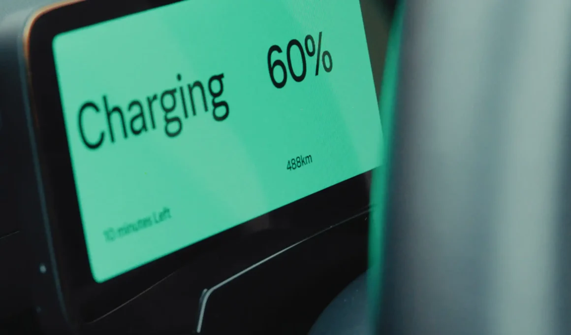 A close-up photograph of crushed orange car metal featuring a yellow and black crash test dummy symbol, overlaid with white text that reads "Volvo Centum" and "Designed with safety in mind," highlighting the new typeface's focus on automotive safety.