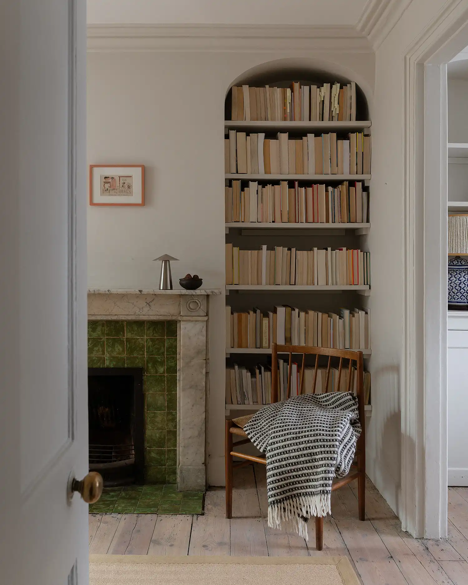 Early 20th-century green tiling and a marble mantelpiece in a historic Hackney home.