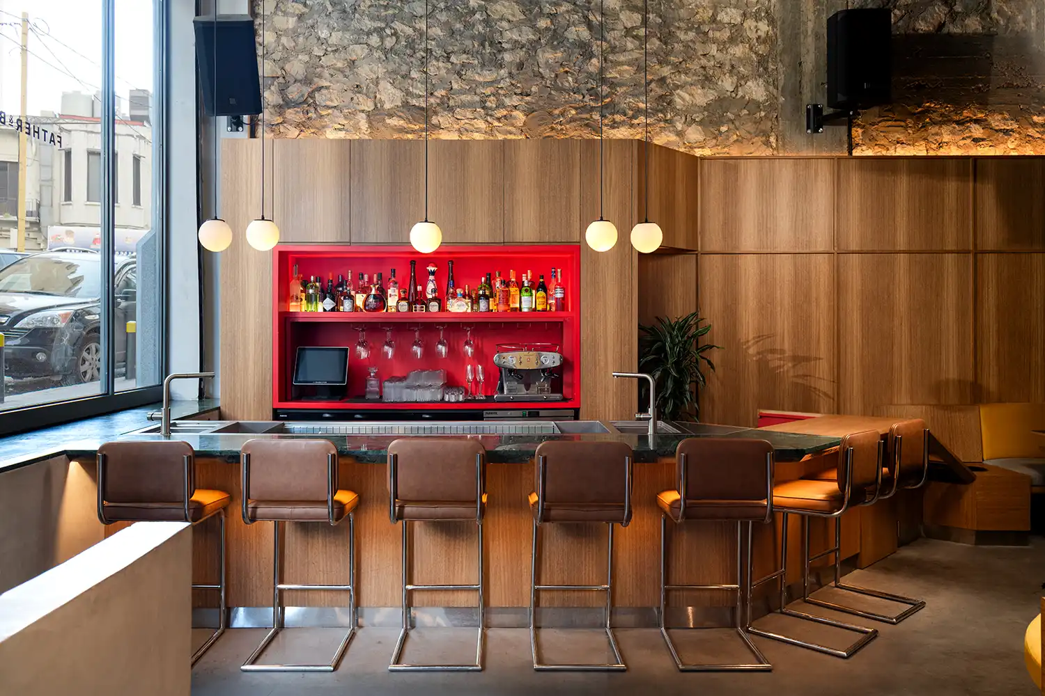 Sculptural bar with red backlit niche
