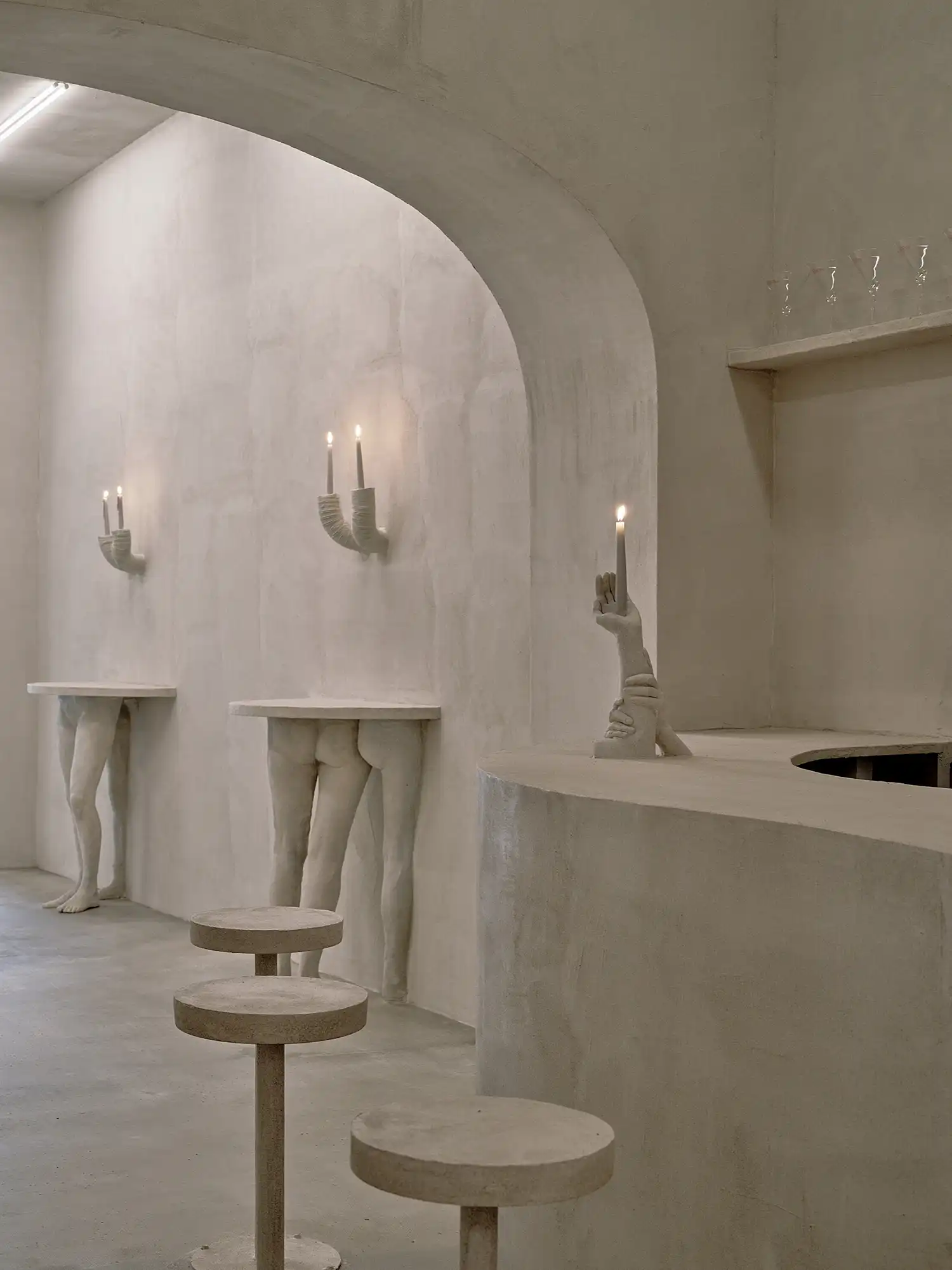 Plaster leg tables and hand-shaped candle holders at Bar Far.