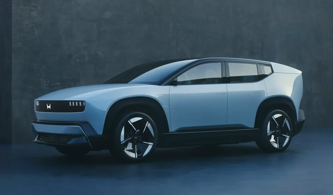 Side profile of the sleek Honda 0 Series electric vehicle concept featuring a seamless, silver metallic body with integrated flush door handles.