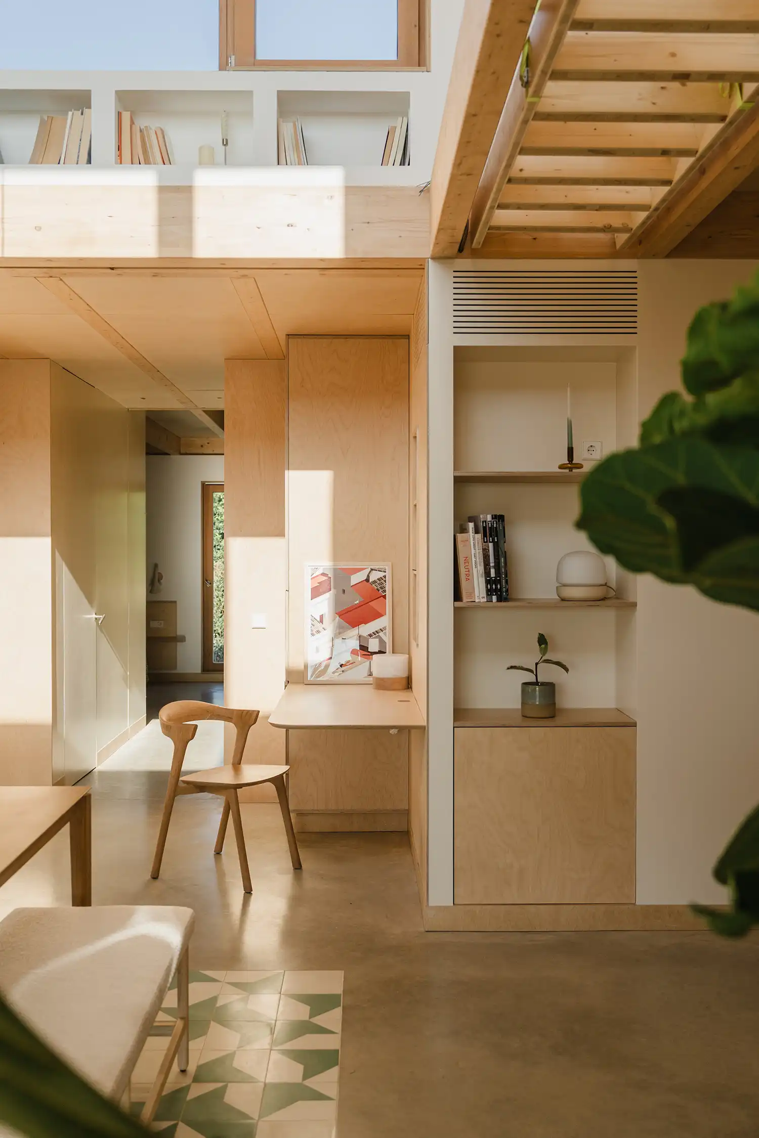 Minimalist timber workstation integrated into the wall with natural wood finishes.