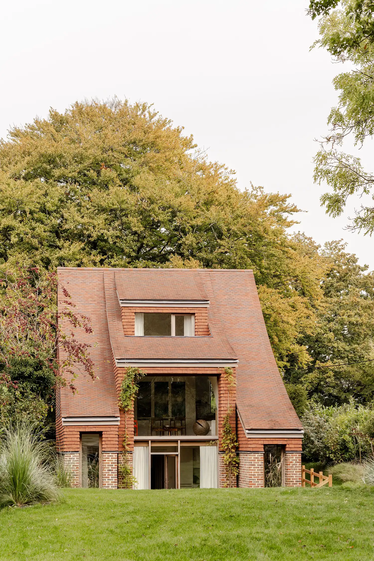 Front elevation of Clay Rise showing brick base, clay upper floors, and large glass openings