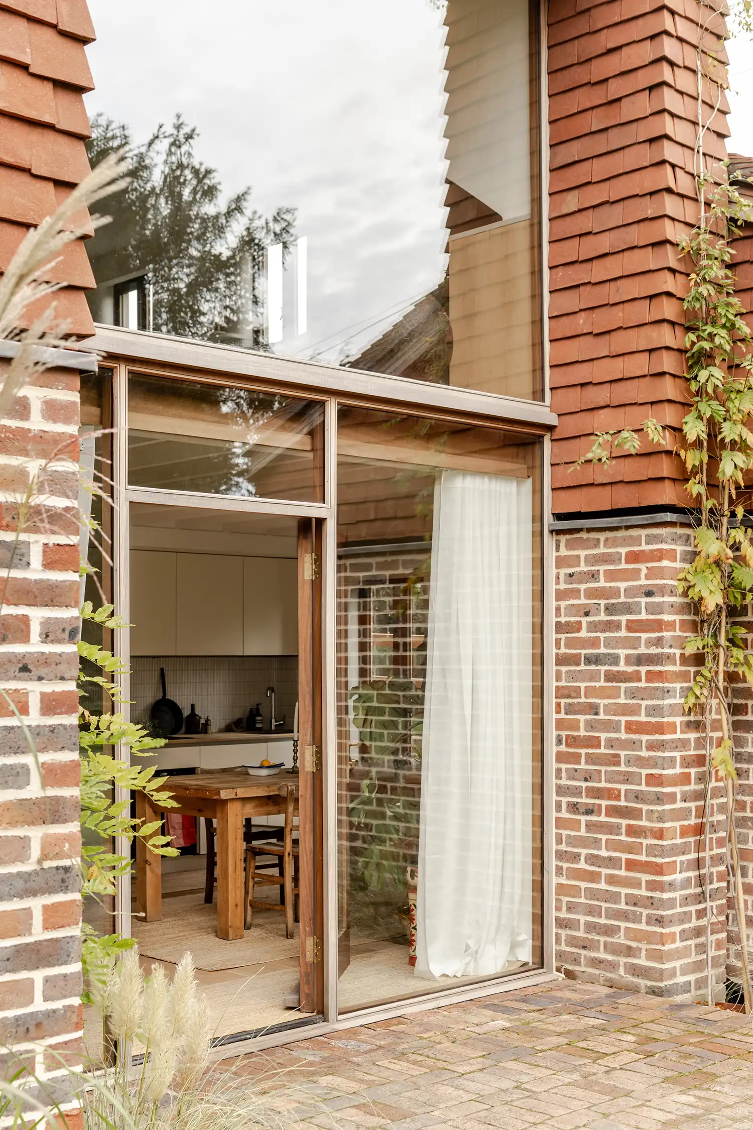 Detail of the ground floor entrance showing brickwork and double-height glazing