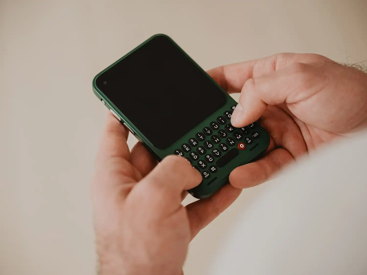 Clover green Clicks Communicator being held by a user.