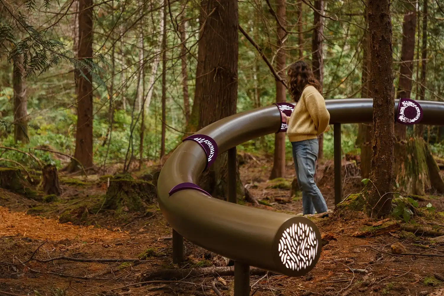 Close-up of a participant examining the glowing interfaces on the metal structure.