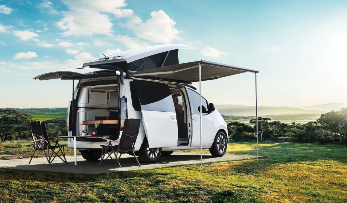 Rear view of Hyundai STARIA Camper Concept with trunk open and side awning extended.
