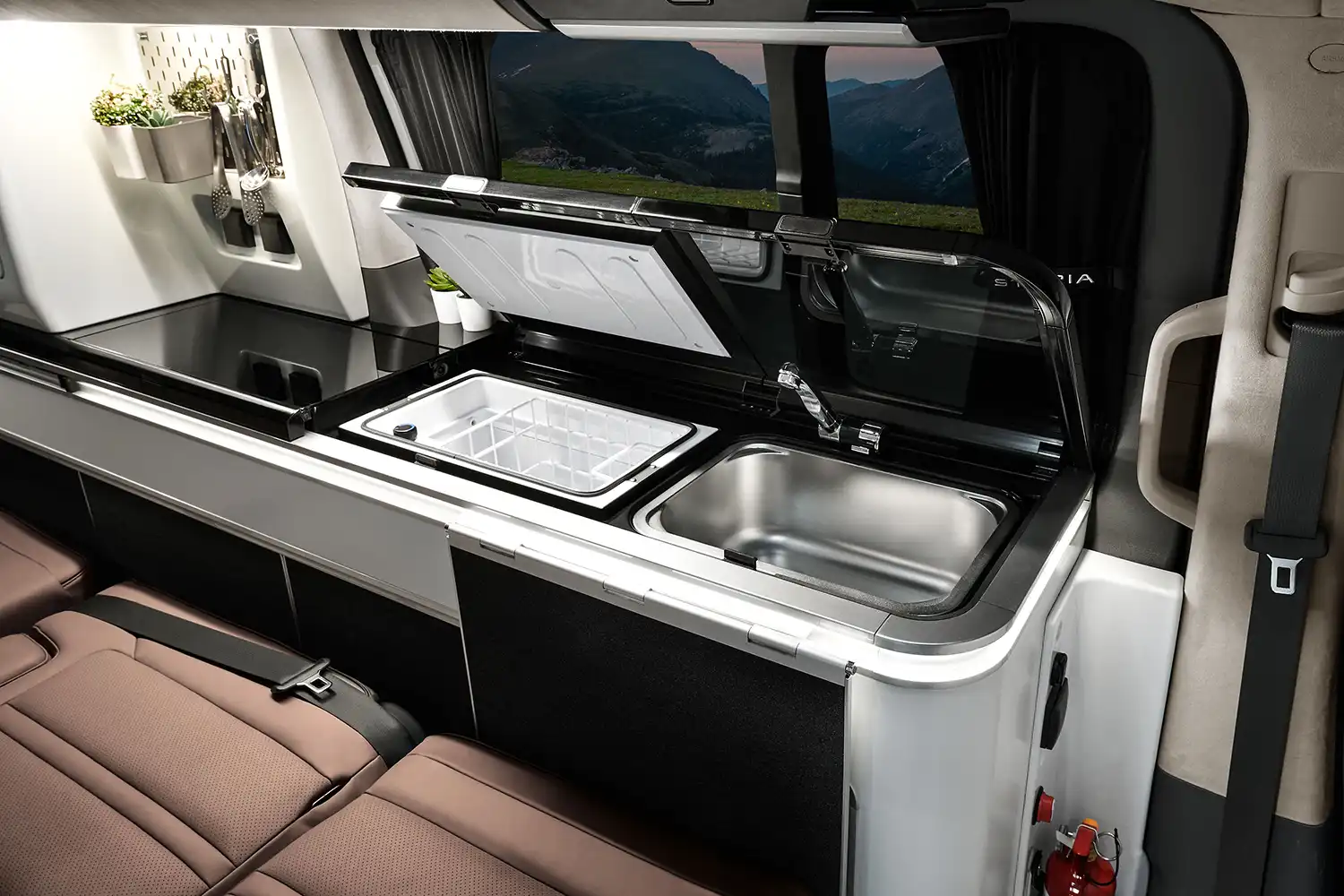 Interior view of the STARIA Camper kitchen module with integrated sink and refrigerator.