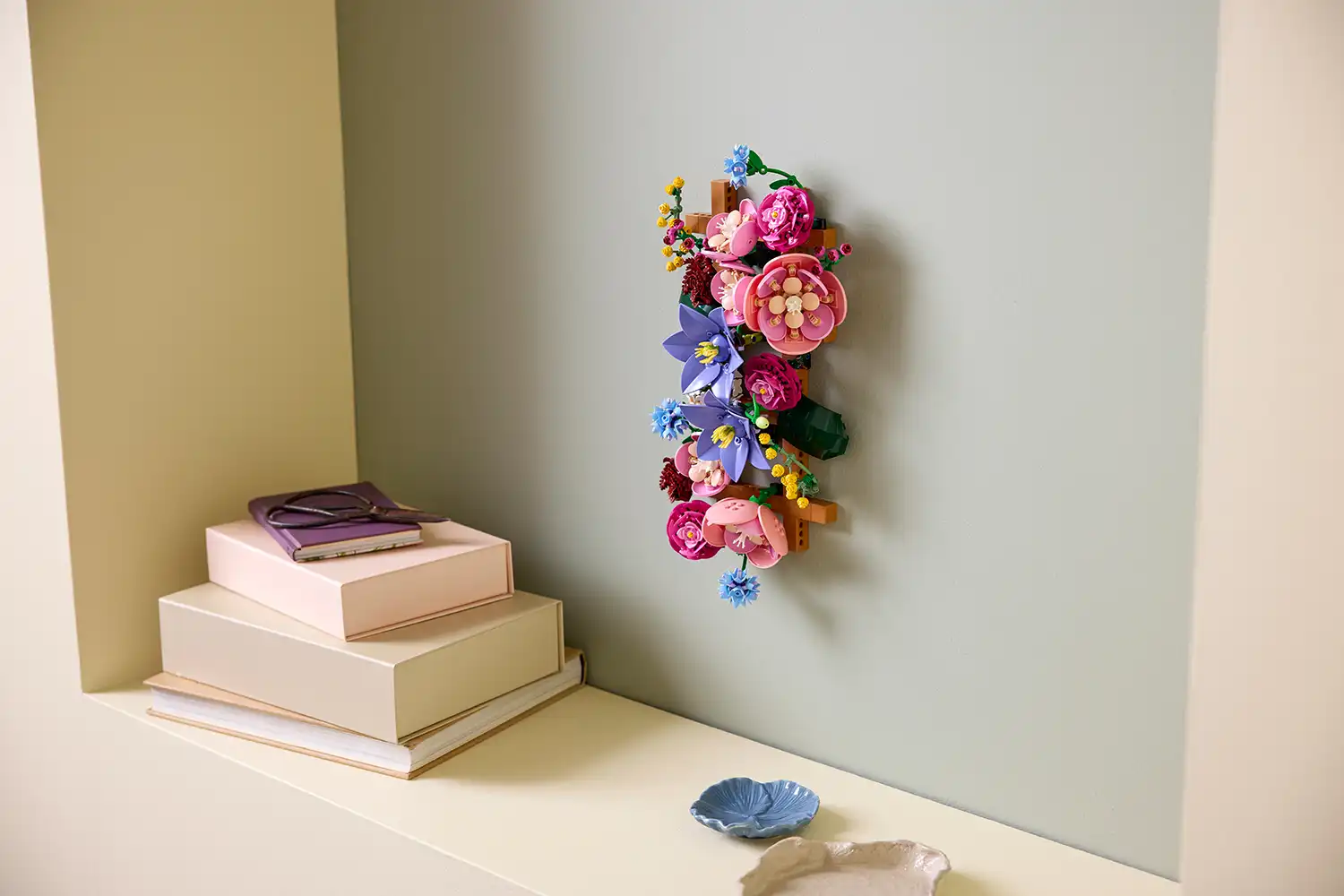 Slim vertical LEGO Flower Wall installation on a sage green wall.