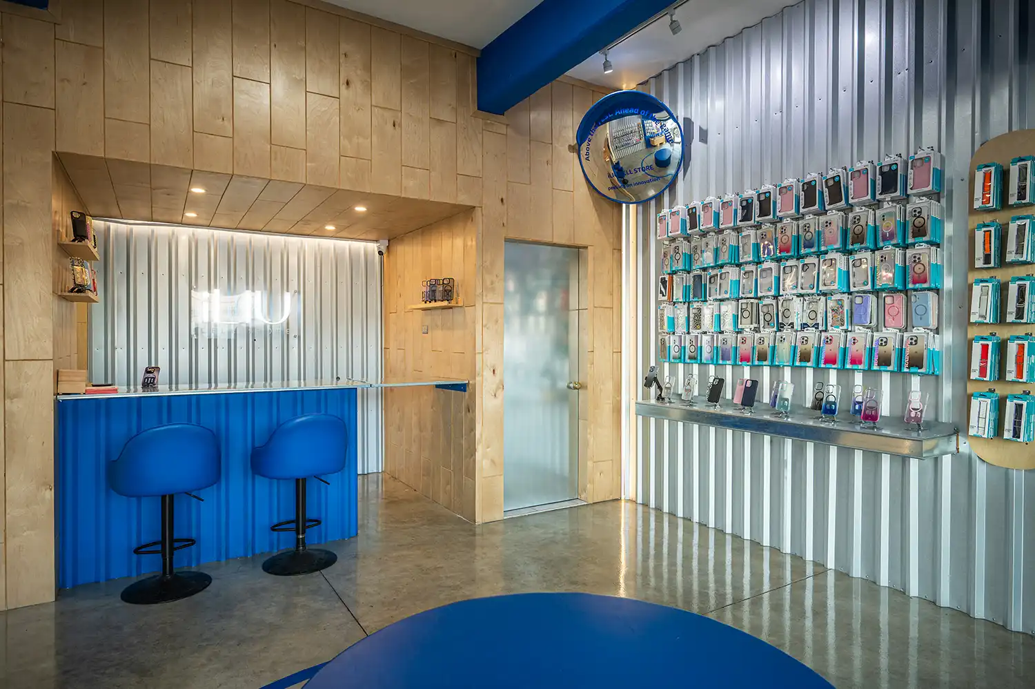 Blue corrugated metal service counter and plywood walls in ILIU repair area.