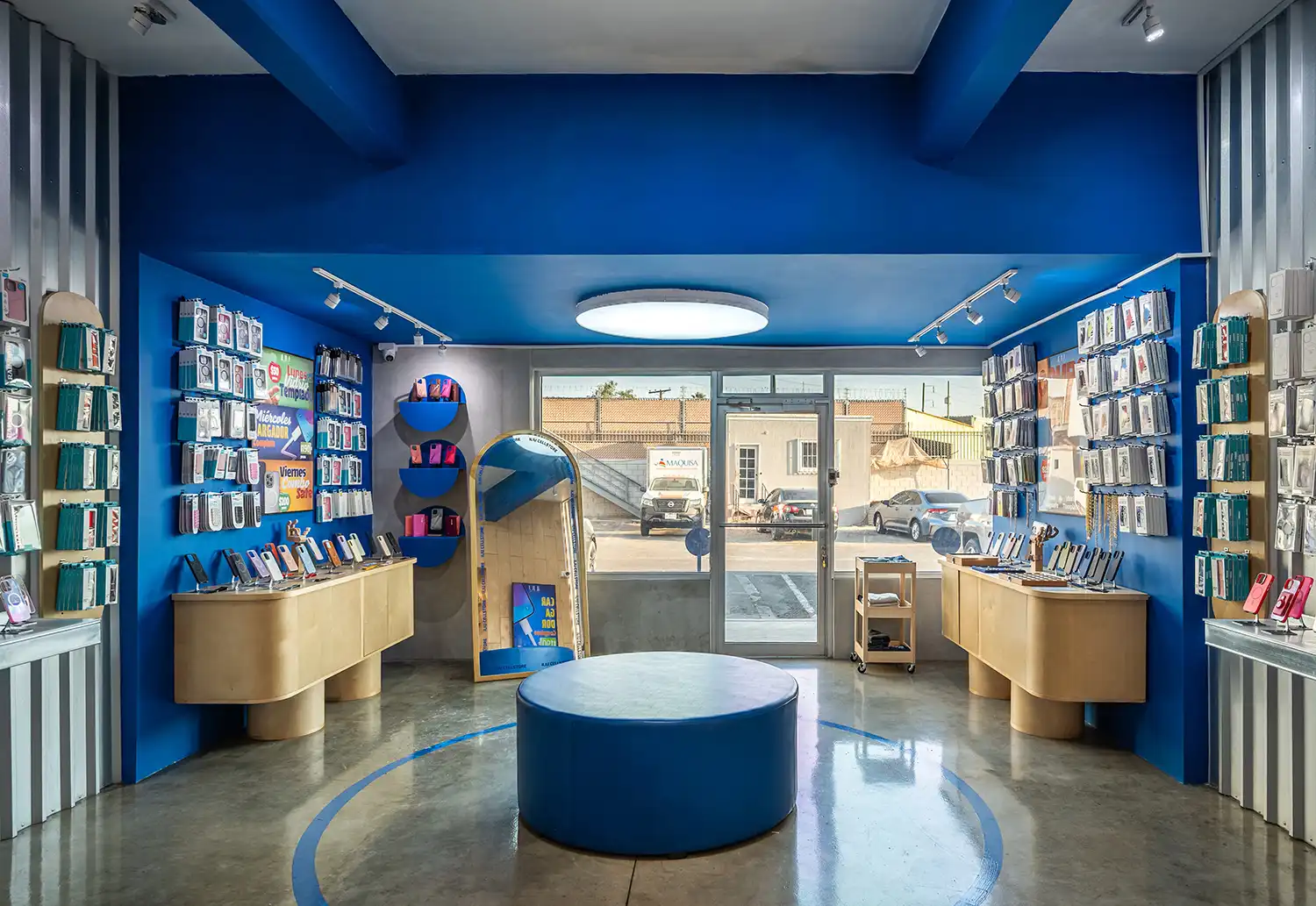 Symmetrical interior view of the store toward the entrance with circular ceiling light.