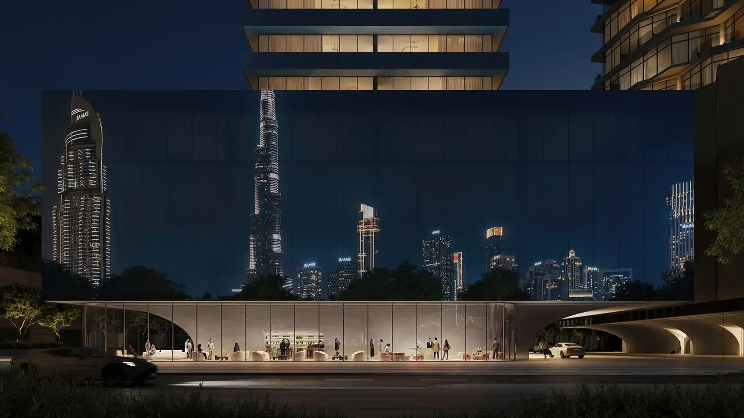 Street-level view of Inaura's transparent plinth reflecting the Dubai skyline at night.