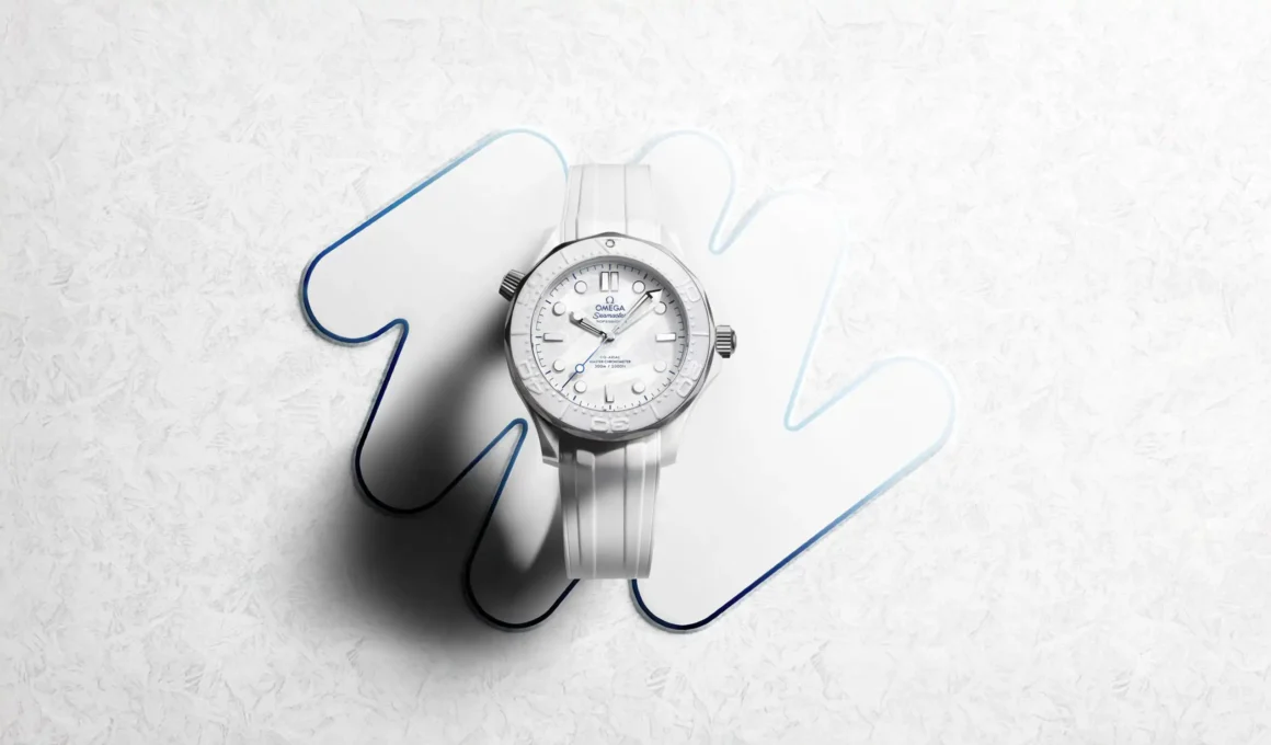 Top-down view of the OMEGA Seamaster Milano Cortina 2026 on a white textured background with blue-edged graphic shapes.