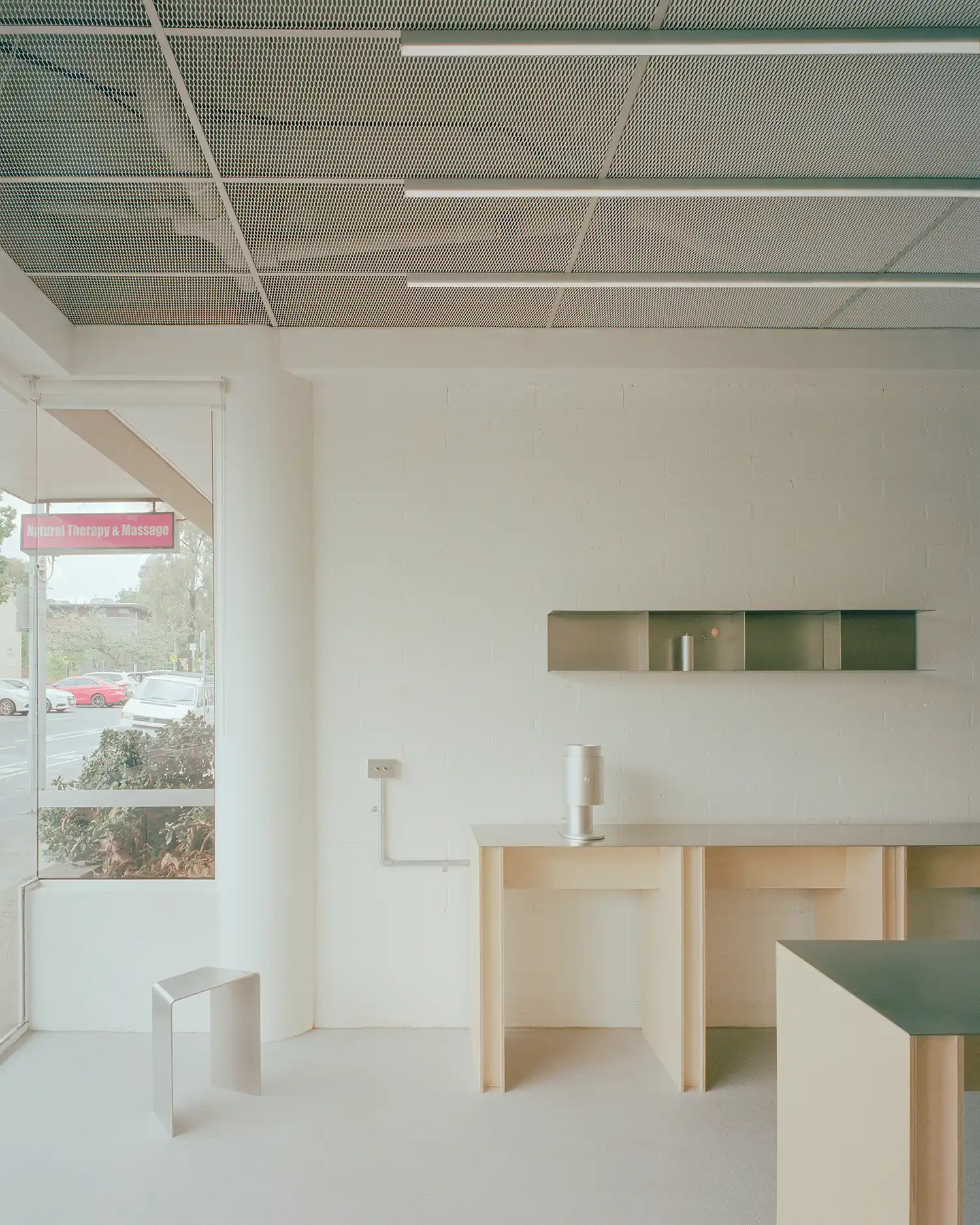 Industrial ceiling detail at Option-O Brew Lab showing perforated metal panels and exposed conduits.