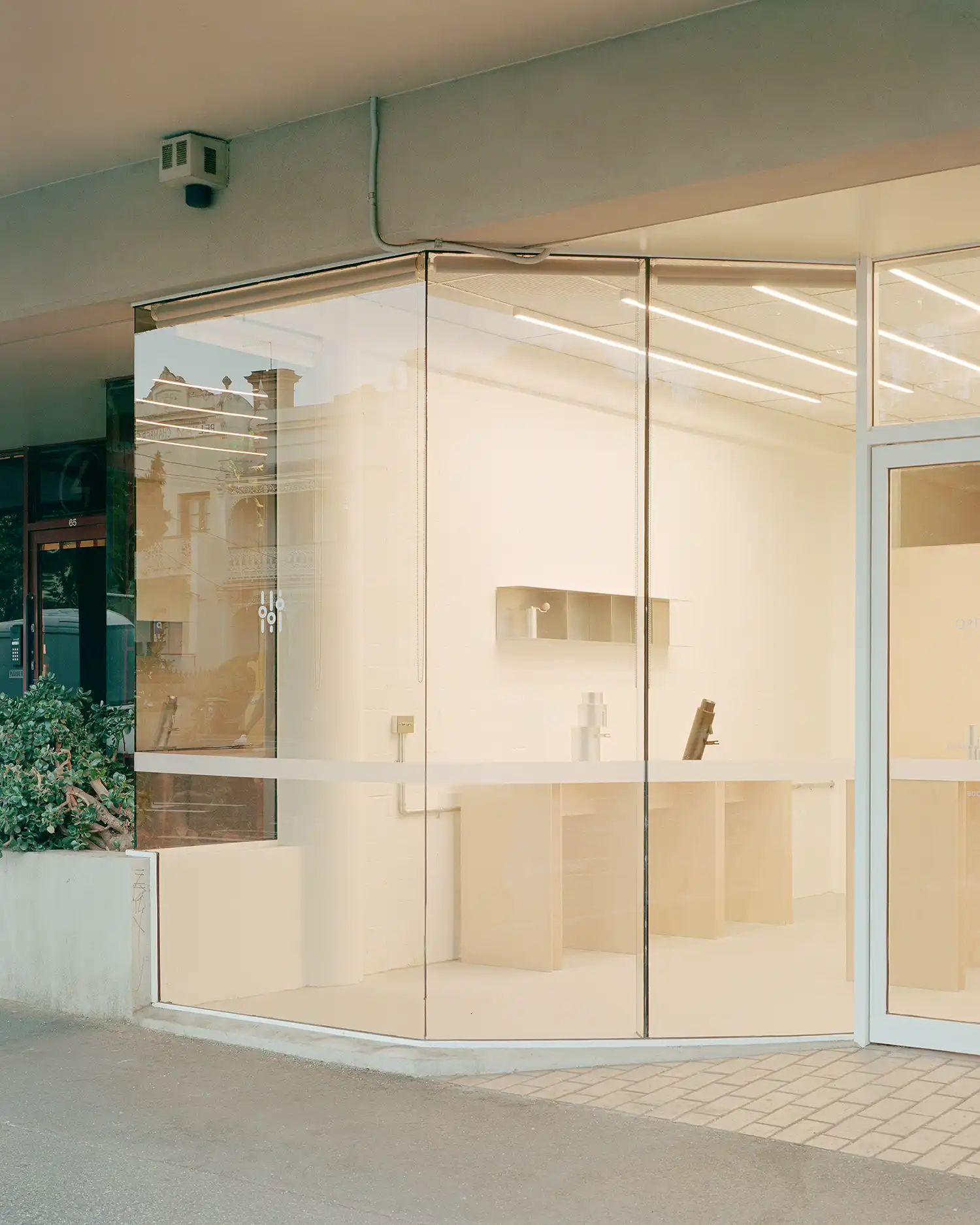 Exterior evening view of the Option-O Brew Lab storefront with glowing minimalist interiors.