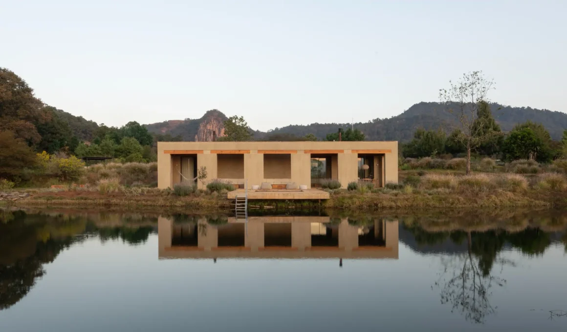 Toronjos house reflecting in a still lake at dusk in Valle de Bravo Mexico by PPAA