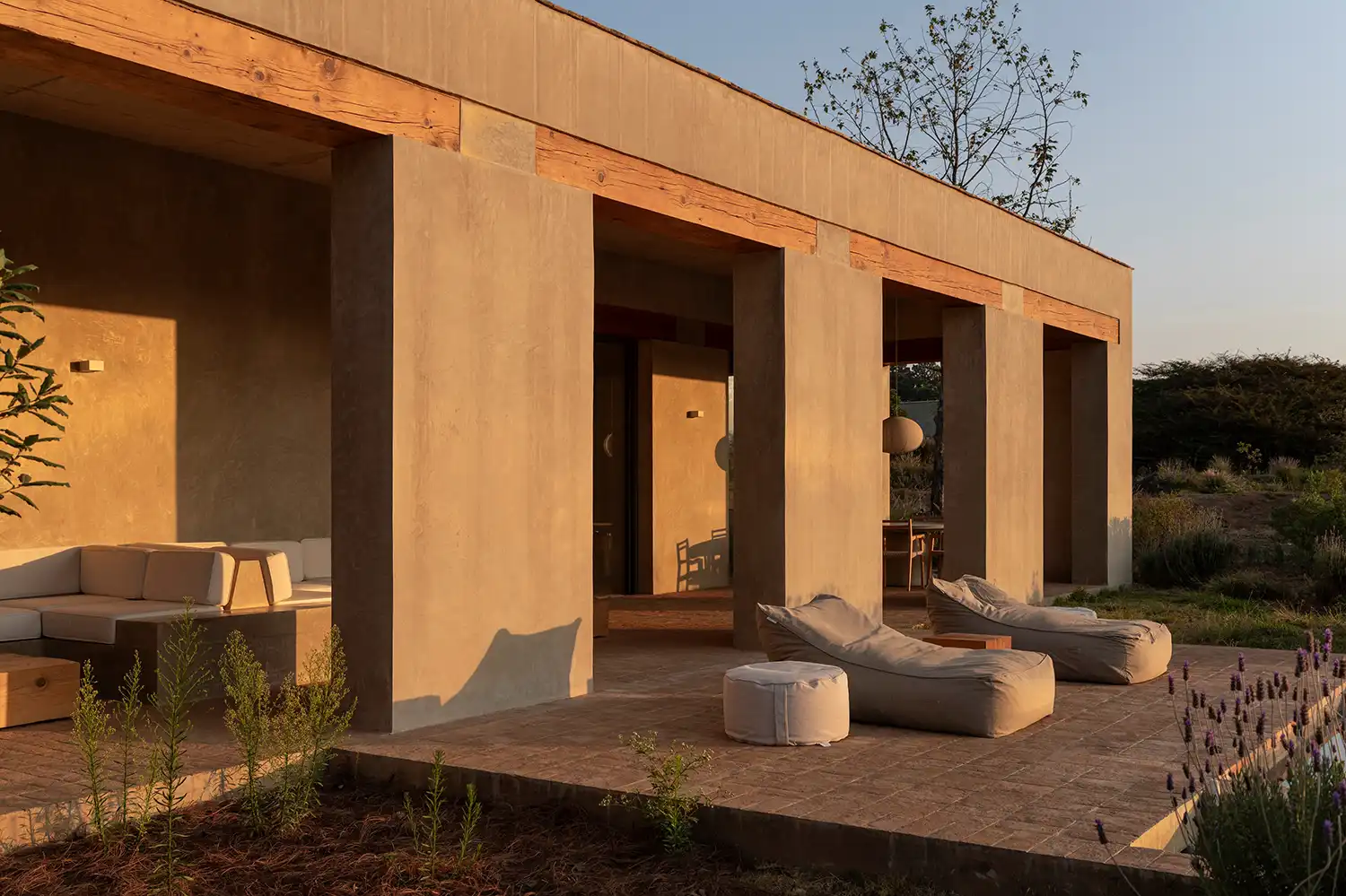 Exterior terrace of Toronjos house featuring bean bags and exposed wooden beams