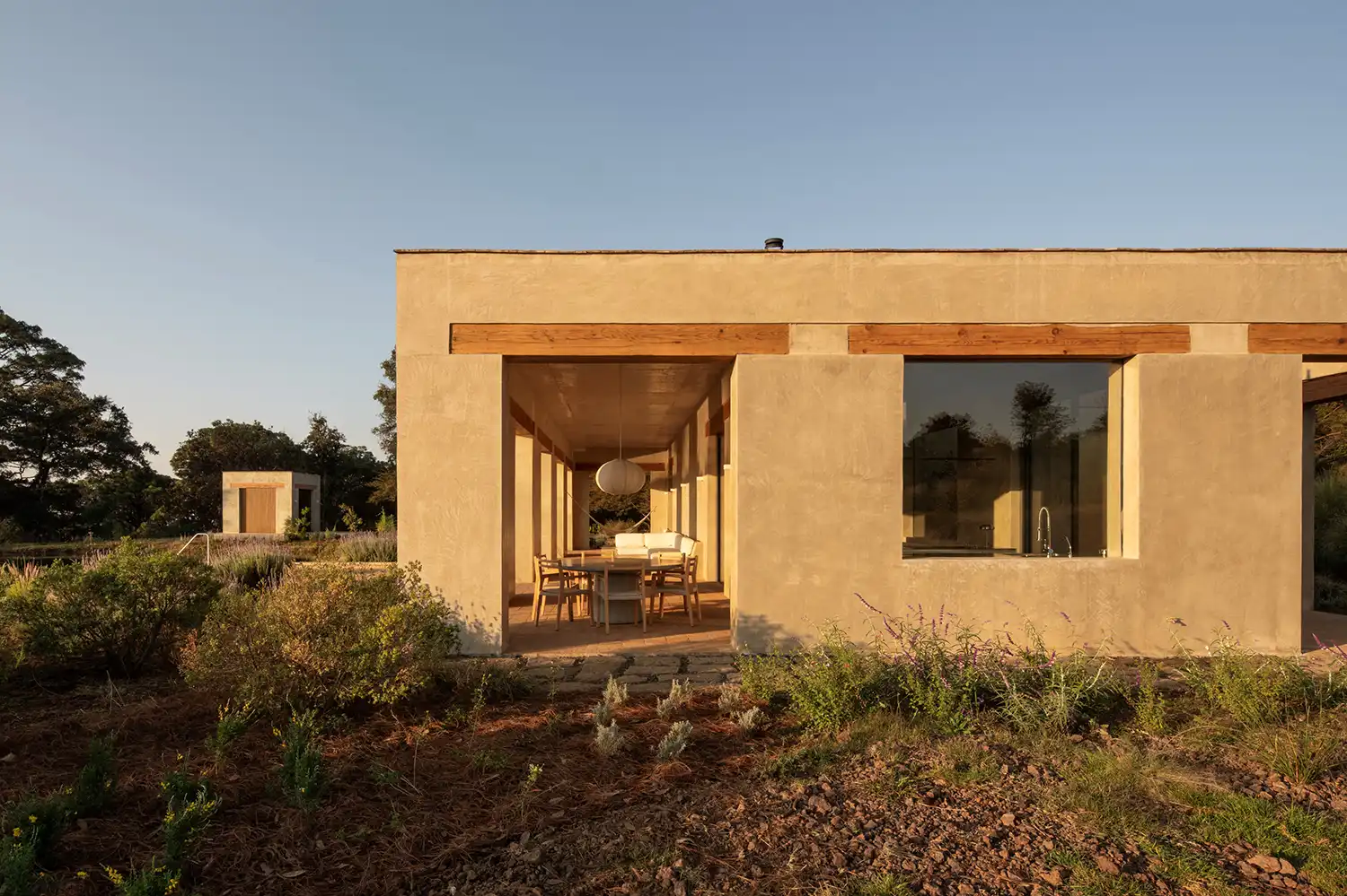 Toronjos summer house side view showing dining area and wild garden landscape