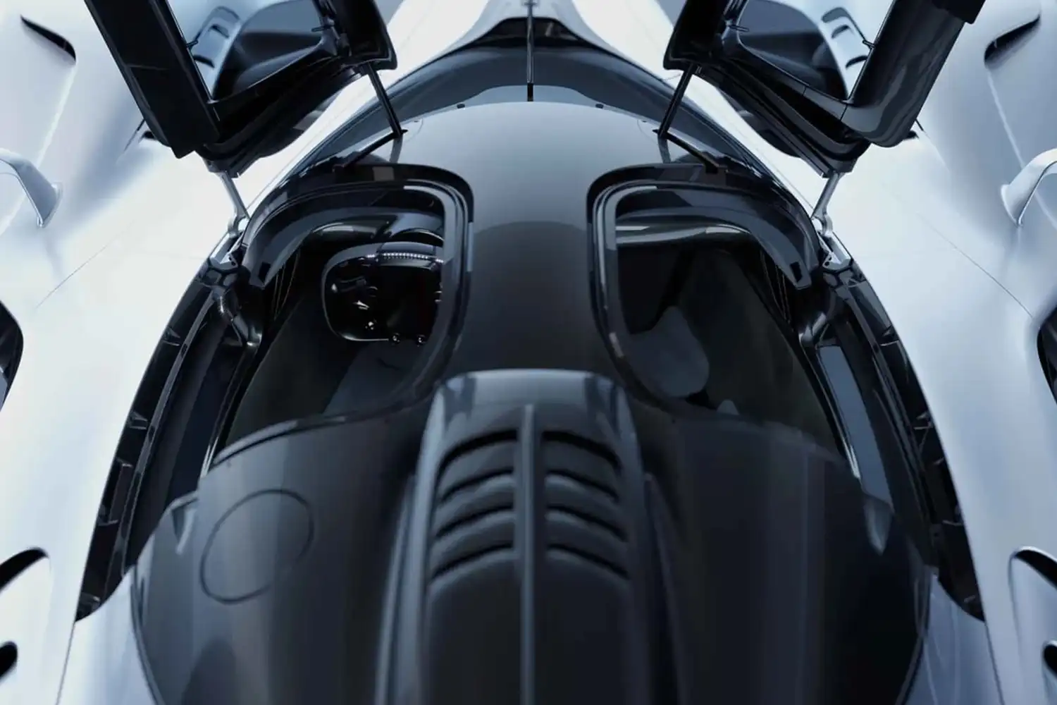 Close-up overhead shot of the RB17 with its butterfly-style doors open, revealing a minimalist, driver-focused cockpit and the carbon fiber structure of the roof.